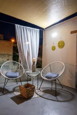 two chairs and a table in front of a window at Casa Ellini unique & spacious by 8essentially in Kókkinos Pírgos