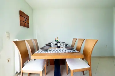 a dining room table with chairs and wine bottles on it at Loft Apartment in Chania Town