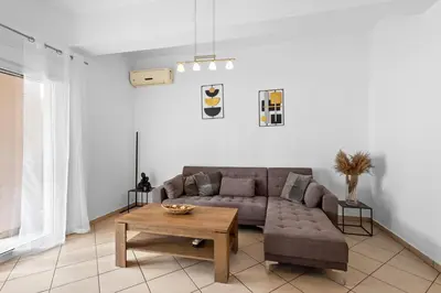 a living room with a couch and a coffee table at Marika's Apartment in Chania in Chania Town