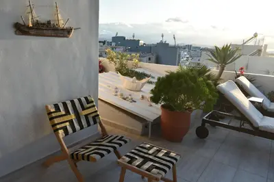 a balcony with a bench and a ship on it at Diotima - Astonishing seaview apartment in Chania Town