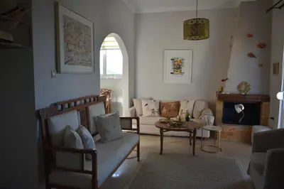 a living room with a couch and a table at Diotima - Astonishing seaview apartment in Chania Town