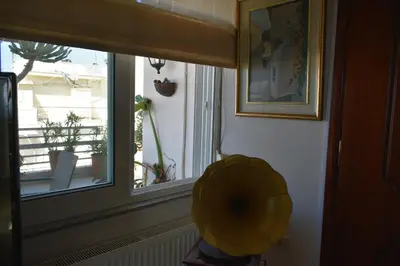 a room with a window with a yellow fan at Diotima - Astonishing seaview apartment in Chania Town