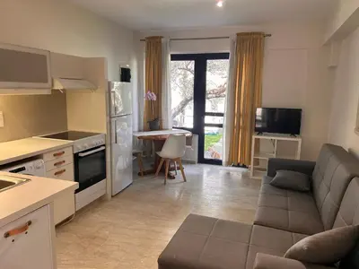 a kitchen and living room with a couch and a table at Elias Nest in Galatás