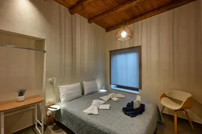 a bedroom with a bed with towels on it at Evans Villas in Kissamos