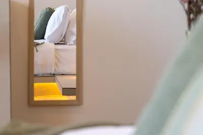a mirror reflection of a bed in a bedroom at Selected Suites in Chania Town