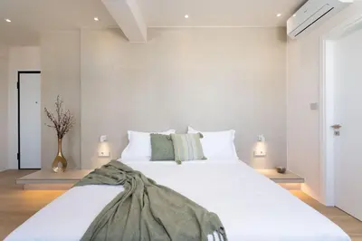 a bedroom with a large bed with white sheets at Selected Suites in Chania Town