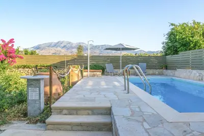 a swimming pool in a backyard with a swimming pool at Villa Rouga by Andrian Villas in Kalamítsion Alexándrou