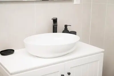 a white sink on top of a white cabinet in a bathroom at Elia Suites in Falasarna