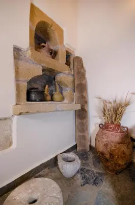 a room with a shelf with artifacts on the wall at Kallimento-Dimitra in Kissamos