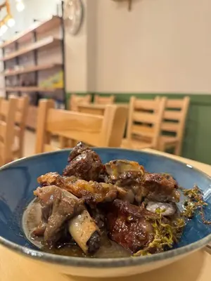 a blue bowl of food on a table at WHITE MOUNTAINS Nature Home in Arménoi
