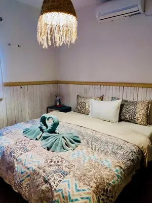 a bedroom with a bed with a blue towel on it at WHITE MOUNTAINS Nature Home in Arménoi