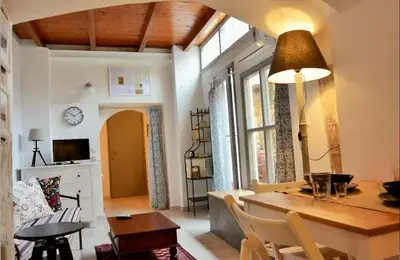 a dining room and living room with a table and chairs at Casa Di Porto Vecchio in Chania Town