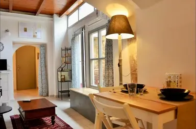 a living room with a dining room table and a dining room at Casa Di Porto Vecchio in Chania Town