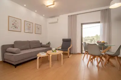 a living room with a couch and chairs and a table at Diktamo apartment, Palaiochora in Palaiochóra