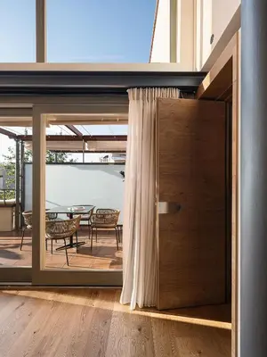 a pivot door in a room with a table and chairs at Elysia Boutique Hotel in Chania Town