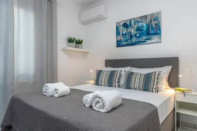 a bedroom with a bed with towels on it at Urban Living City Apartment in Chania Town