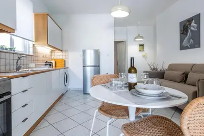 a kitchen with a table with a bottle of wine at Urban Living City Apartment in Chania Town