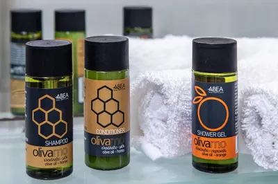 three bottles of olive oil sitting on a table at Urban Living City Apartment in Chania Town