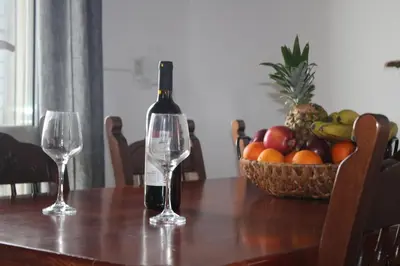 a bottle of wine sitting on a table with two glasses at Sea Sight Vibes in Frangokastello