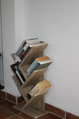 a wooden book shelf filled with books next to a wall at Sea Sight Vibes in Frangokastello