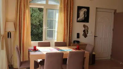 a dining room table with chairs and a window at Constantin in Dhémbla