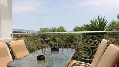 a table and chairs on a balcony with a view at Constantin in Dhémbla