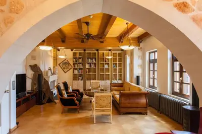 an archway in a living room with chairs and a table at Luxurious Venetian 3 FLOOR HOUSE in the old port in Chania Town