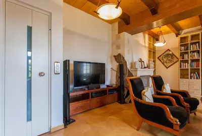 a living room with a flat screen tv and chairs at Luxurious Venetian 3 FLOOR HOUSE in the old port in Chania Town