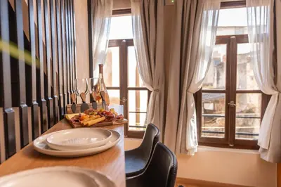 a table with a plate of food and a window at Mimosa Veneziano - Sauna - Old Town Chania in Chania Town