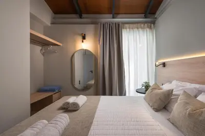 a bedroom with a large bed with a large mirror at Natura Hill Villa II Sunset View in Kounoupidhianá
