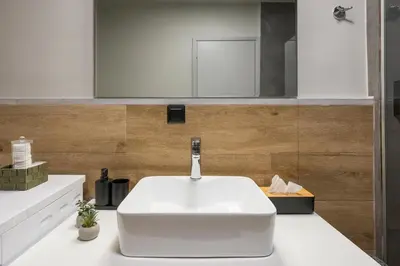a bathroom with a white sink on a counter at Natura Hill Villa II Sunset View in Kounoupidhianá