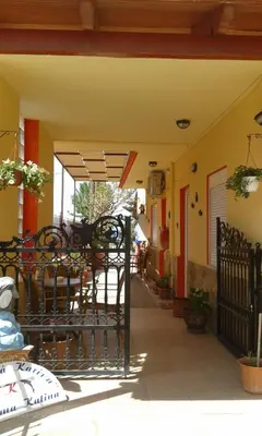 a patio of a restaurant with tables and chairs at Gradma Katina in Plataniás