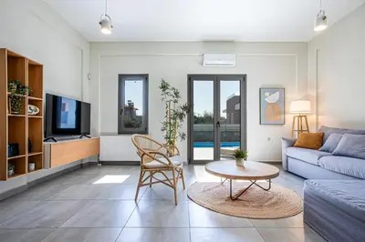 a living room with a couch and a table at Anassa Natura Villa in Daratso