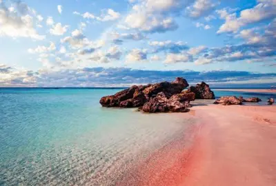 a beach with some rocks in the water at theVotsalo Eco house in Agios Padeleimon