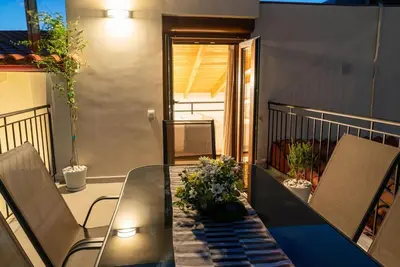 a dining table and chairs on a balcony at Sappho 3-bedroom House in Daratso