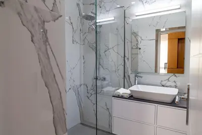a bathroom with a sink and a glass shower at Sappho 3-bedroom House in Daratso