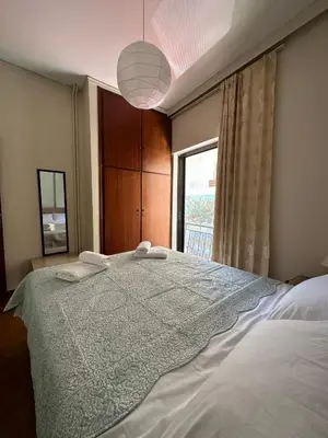 a bedroom with a large bed with a window at Haris home 1 in Chania Town
