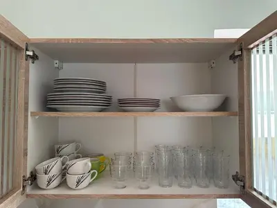 a shelf filled with glasses and plates and bowls at Haris home 1 in Chania Town