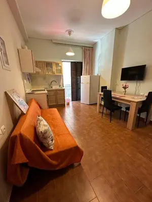 a living room with a couch and a kitchen at Haris home 1 in Chania Town