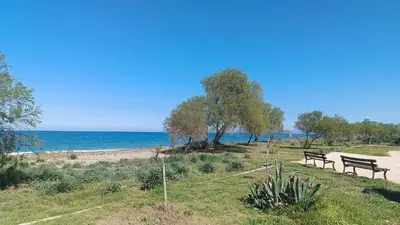 two benches sitting on the side of a beach at Relax Private Pool House in Maleme