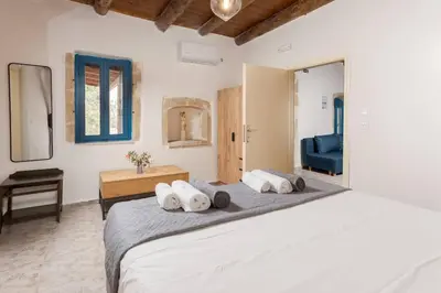 a bedroom with a large bed with towels on it at Halases Panorama Villa pvt pool in Alikampos