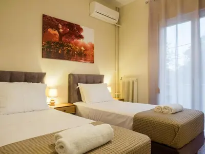 a hotel room with two beds and a window at Atenà Urban Living in Chania Town