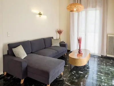 a living room with a couch and a table at Atenà Urban Living in Chania Town