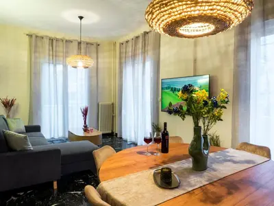 a living room with a table with glasses of wine at Atenà Urban Living in Chania Town