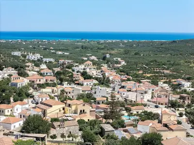 an aerial view of a town with houses and the ocean at Feli Living in Spiliá