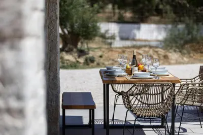 a wooden table with glasses and a bottle of wine at Feli Living in Spiliá