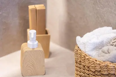 a bottle of soap next to a basket of towels at Feli Living in Spiliá