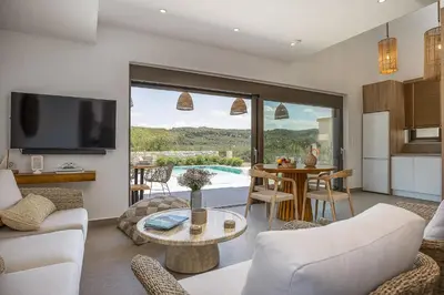 a living room with a couch and a table at Feli Living in Spiliá