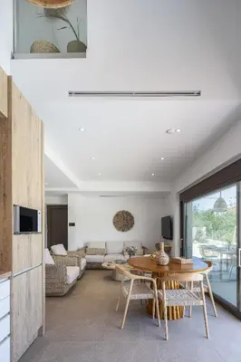 a living room with a table and a couch at Feli Living in Spiliá