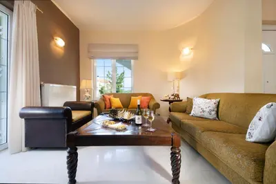 a living room with a couch and a table at Casa BI LA in Galatás